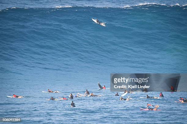 a crowd of big wave surfers wait in the line-up for the perfect wave - big wave surfing stock pictures, royalty-free photos & images