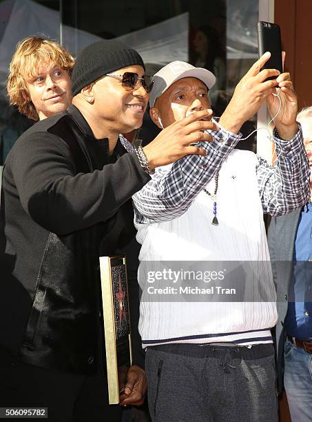 Cool J and Russell Simmons while Eric Christian Olsen photobombs at the ceremony honoring LL Cool J with a Star on The Hollywood Walk of Fame held on...