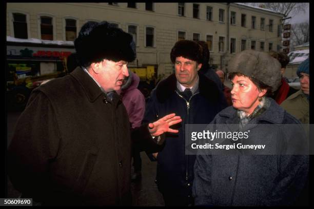 Right-wing nationalist Liberal Dem. Party ldr. Vladimir Zhirinovsky making point, lecturing hostile pedestrian , on street .