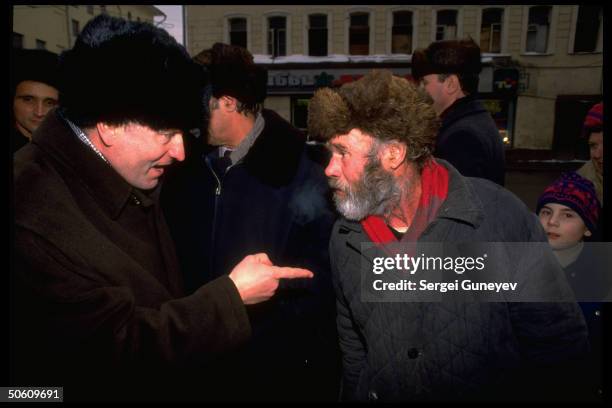 Right-wing nationalist Liberal Dem. Party ldr. Vladimir Zhirinovsky making point, lecturing hostile pedestrian , on street .