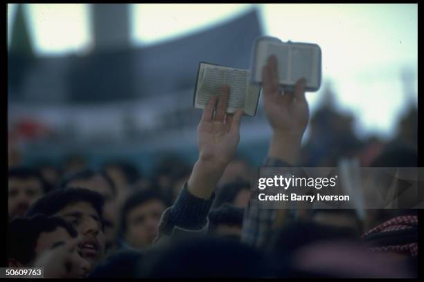Korans held aloft by members of Muslim Brotherhood joining in mass pro-Iraqi demo as outbreak of gulf war appears imminent.