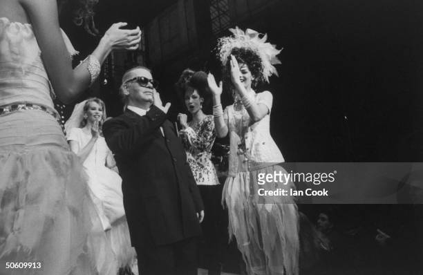 Fashion designer Karl Lagerfeld w. Supermodels Linda Evangelista & Claudia Schiffer wearing his creations & clapping behind him at Chanel spring show.