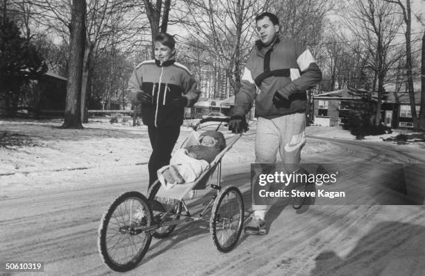 Ice skating commentator for the Winter Olympics, former ice dancer Tracy Wilson w. Her husband Brad Kinsella running while pushing their baby Shane...