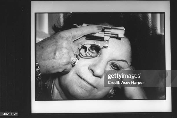 Ex-mob girl Arlyne Brickman who was an informant for the FBI on several members of the Mafia, holding a .38 caliber snub-nosed revolver's trigger...