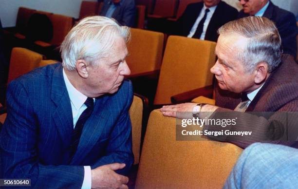 Former Soviet Politburo communist hardliner Yegor Ligachev conferring w. Vladimir Ivashko, former dep. To Soviet Pres. Gorbachev, in courtrm. During...