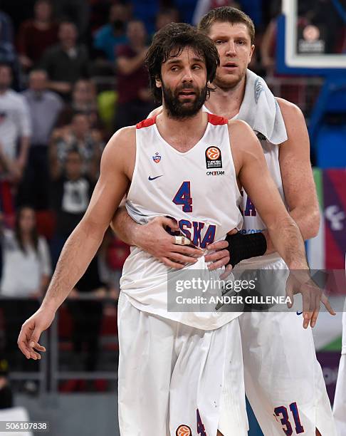 Moscow's Serbian guard Milos Teodosic is hold by teammate forward Victor Khryapa at the end of the Euroleague group F Top 16 round 4 basketball match...