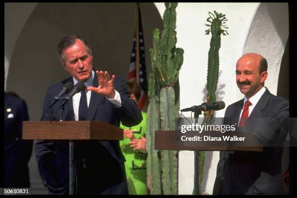 Pres. Bush holding sway at podium, w. Mexican Pres. Carlos Salinas de Gortari by his side, speaking re proposed N. Amer. Free Trade Agreement.