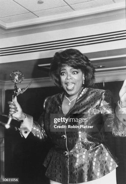 Outstanding Talk Show Host winner Oprah Winfrey looking excited backstage at the Daytime Emmy Awards.