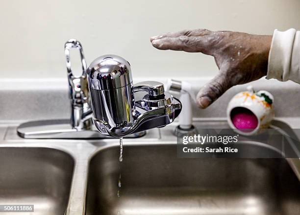 Fred the handyman at the Shiloh Commons installs a new water filter in a residence January 21, 2016 in Flint, Michigan. The city's water supply had...