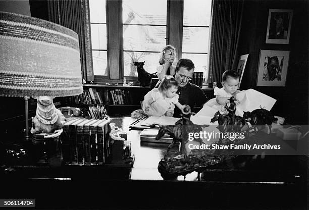 John Wayne at home with his children and grandchildren in 1960 in Encino, California.