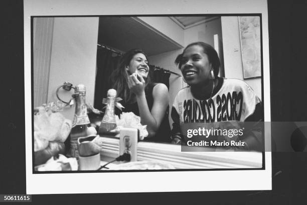 Twentysomething non-actor cast members of MTV documentary The Real World Julie Oliver & Heather Gardner chatting as they sit in front of mirror while...
