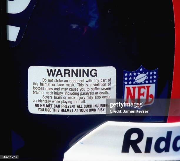 Warning label fr. Riddell football helmet pointing out serious injury which could result fr. Wearer using equipment as defensive weapon.