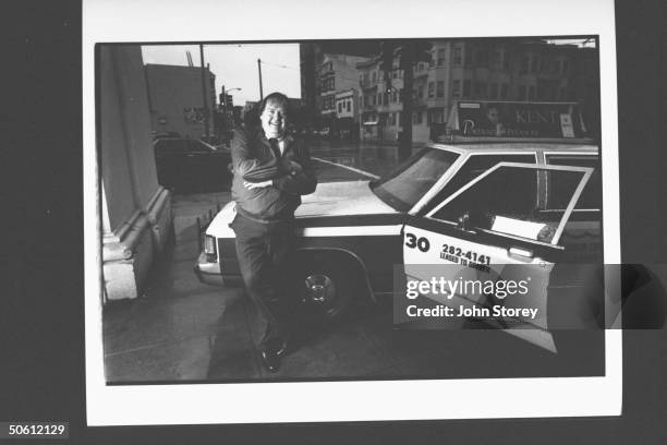 Vigilante cab driver Chuck Hollom leaning against his taxi; he ran down a mugger w. It in 1989 & now faces retrial of lawsuit that awarded the...