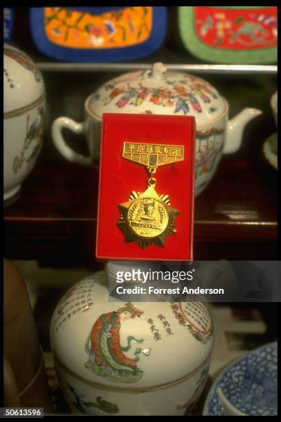 Medal awarded soldier for his part in crackdown on Tiananmen June, 1989 pro-democracy demo displayed in antique shop, unloaded by its owner.