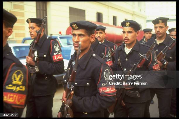 Rifle-armed police in aftermath of bomb blast outside civil defense offices , re Islamic fundamentalist terror.