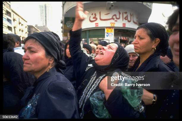 Emoting women amid mourners at funeral for policeman killed in bomb blast by civil defense offices while handling plant bag, re Islamic...