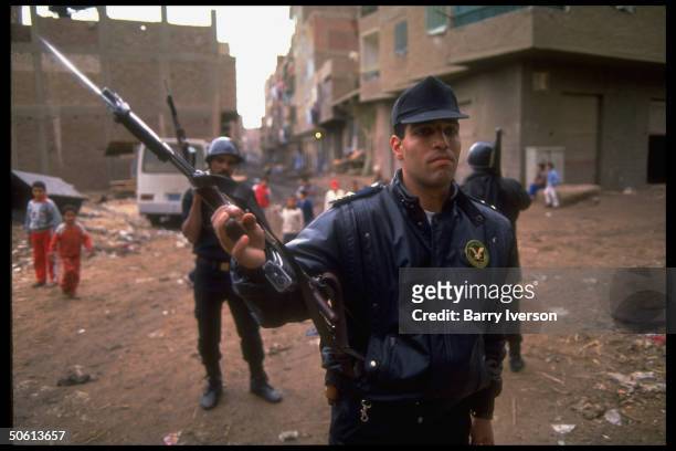 Armed police in slum streets during massive op netting extremists & radicals in Cairo suburb Muslim fundamentalist stronghold Imbaba.