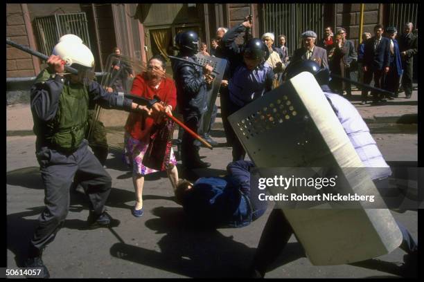 Woman emoting as Special Int. Ministry riot police beat man, in May Day pro-Communist, anti-Yeltsin demo ending in violent clash.