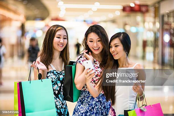 asian friends doing shopping together in singapore - tourist shopping stock pictures, royalty-free photos & images