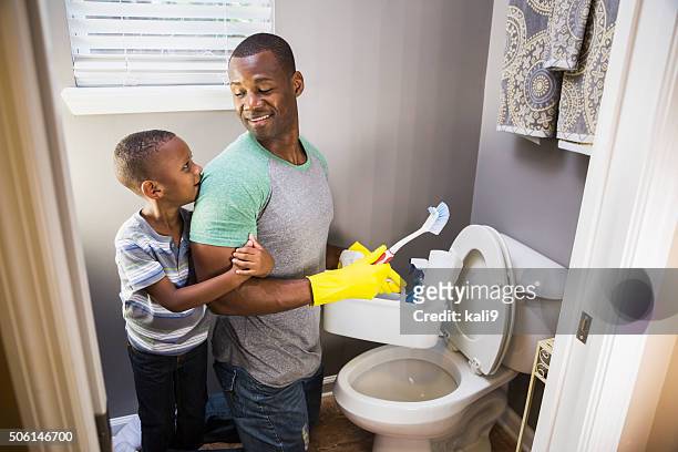 african american man with son, cleaning bathroom toilet - boy looking over shoulder stock pictures, royalty-free photos & images