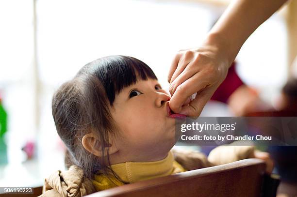 little girl eating strawberry - chandler strawberry stock pictures, royalty-free photos & images