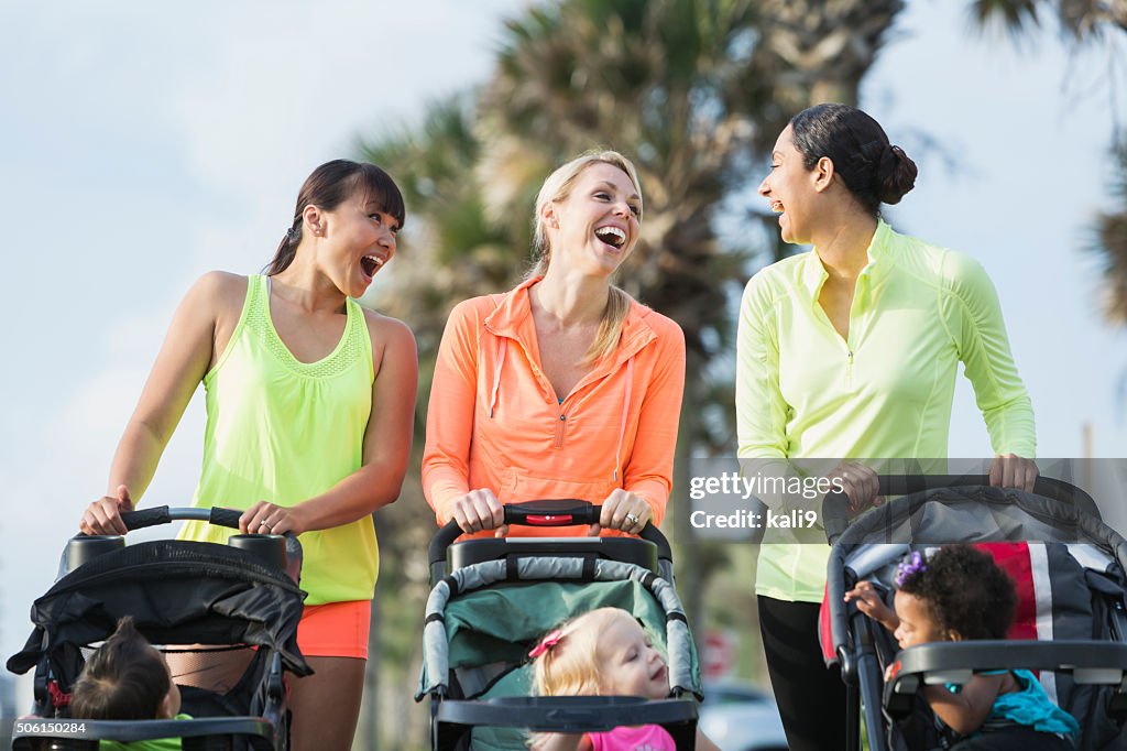 Multi-racial mothers with babies in jogging strollers