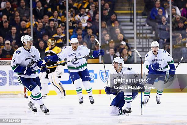 Alex Burrows of the Vancouver Canucks, second from right, celebrates wiht Luca Sbisa and Linden Vey after scoring against the Boston Bruins during...