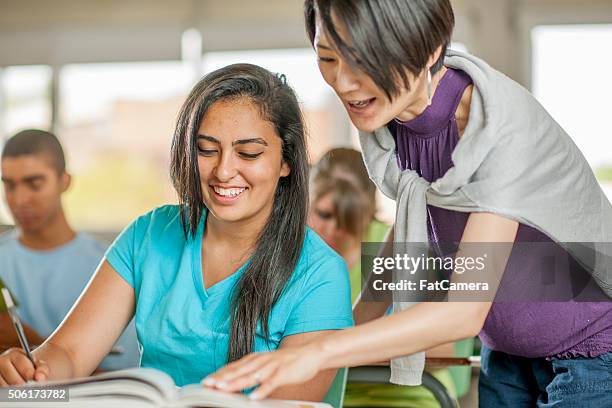helping a student with a question - secondary school building stock pictures, royalty-free photos & images