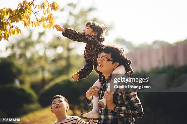 father carrying daughter on shoulders - ulsan stock pictures, royalty-free photos & images
