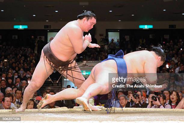 Mongolian yokozuna Hakuho throws ozeki Goeido to win during day twelve of the Grand Sumo New Year Tournament at Ryogoku Kokugikan on January 21, 2016...