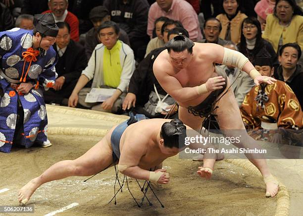 Mongolian yokozuna Hakuho throws ozeki Goeido to win during day twelve of the Grand Sumo New Year Tournament at Ryogoku Kokugikan on January 21, 2016...