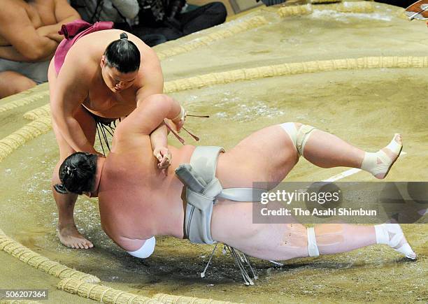 Mitakeumi throws Toyohibiki to win during day twelve of the Grand Sumo New Year Tournament at Ryogoku Kokugikan on January 21, 2016 in Tokyo, Japan.