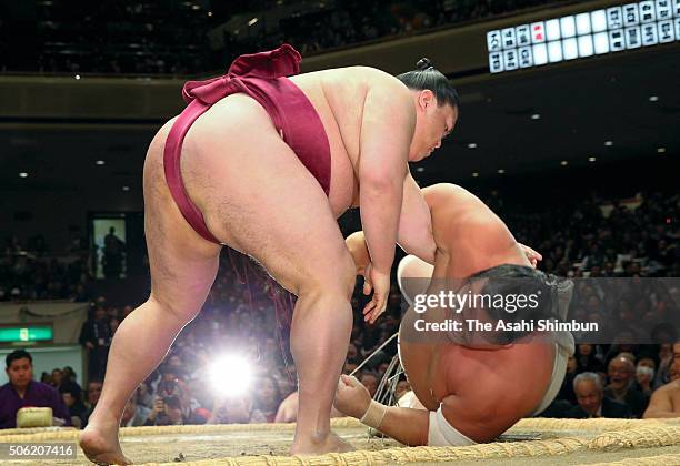 Mitakeumi throws Toyohibiki to win during day twelve of the Grand Sumo New Year Tournament at Ryogoku Kokugikan on January 21, 2016 in Tokyo, Japan.