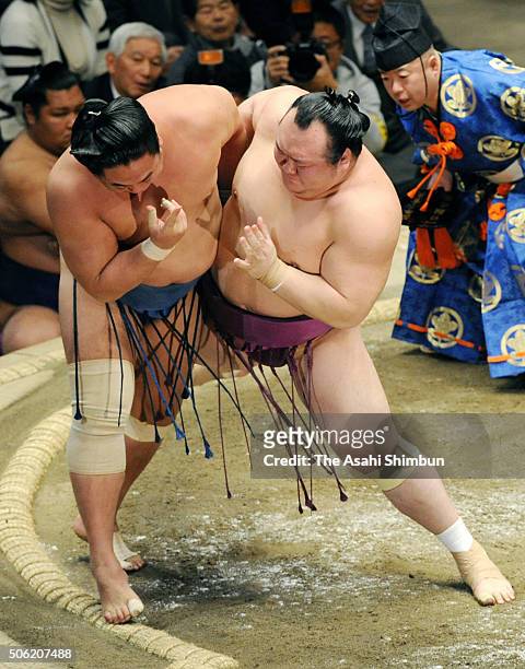 Takarafuji pushes Mongolian wrestler Kyokushuho out of the ring to win during day twelve of the Grand Sumo New Year Tournament at Ryogoku Kokugikan...