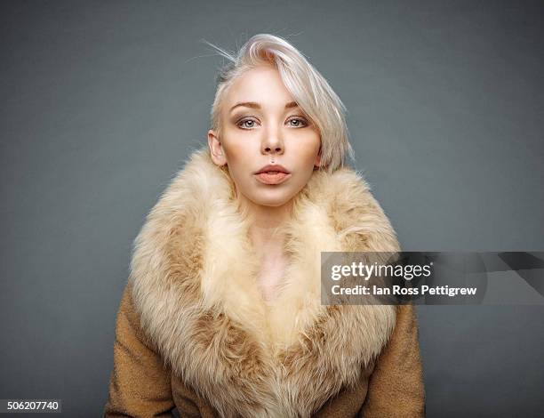 portrait of model with blonde hair in fur coat - fur coat stock pictures, royalty-free photos & images