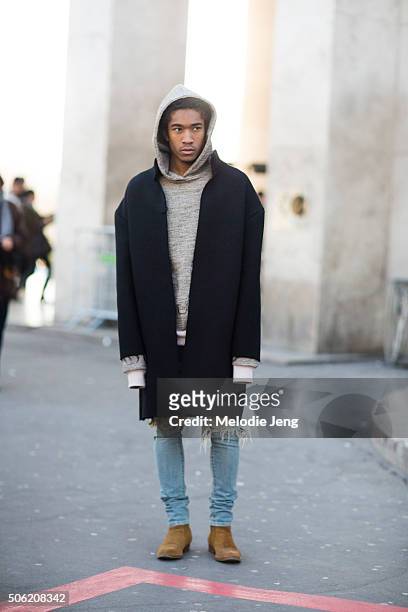 Designer Anthony Calydon wears Nobless Couture gray hoodie, black jacket, denim jeans, and Chelsea boots on January 21, 2016 in Paris, France.