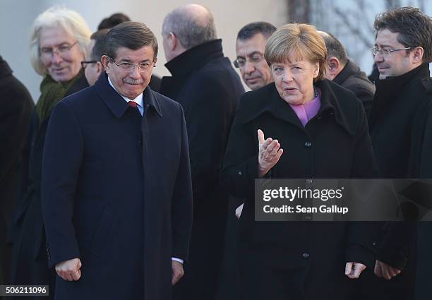 Turkish Prime Minister Ahmet Davutoglu and German Chancellor Angela Merkel walk together following Devatoglu's arrival prior to German-Turkish...