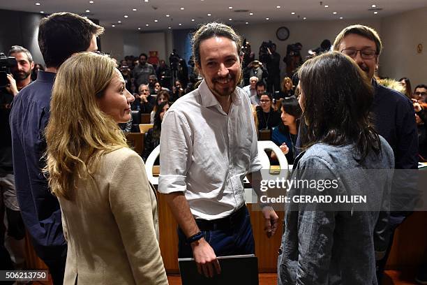 Leader of left-wing political party Podemos, Pablo Iglesias poses smiles next to party mate, Victoria Rosell , prior to giving a press conference at...