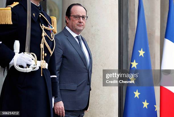 French President Francois Hollande stands prior to a meeting with Tunisian Prime Minister Habib Essid at the Elysee Presidential Palace on January...