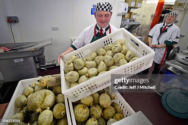 Brian Barclay manager at Crombies butchers and butcher Sam Andrews finish preparing haggis ahead of Burns night on January 22, 2016 in Edinburgh,...