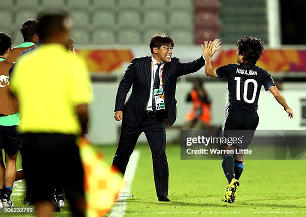 Shoya Nakajima of Japan is congraulated by Makoto Teguramori, Head Coach of Japan after scoring a goal in extra time during the AFC U-23 Championship...