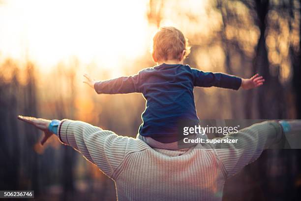 photo of grandfather and his grandson in the park - differential focus stock pictures, royalty-free photos & images