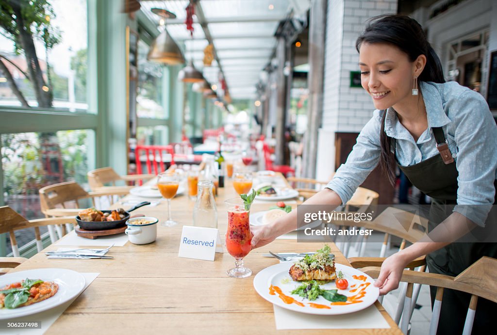 Waitress serving dinner at a restaurant