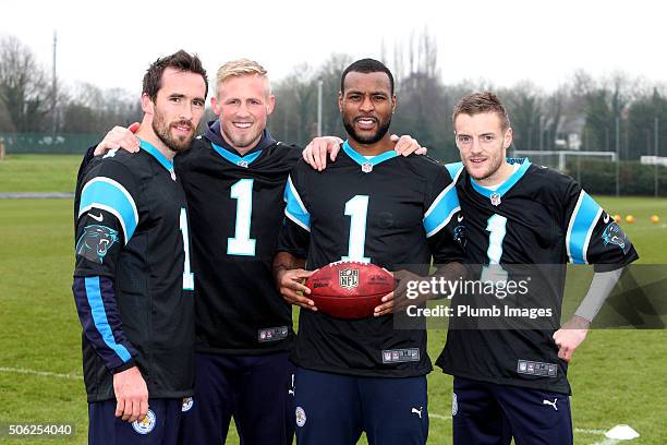 Leicester City's Christian Fuchs, Kasper Schmeichel, Wes Morgan and Jamie Vardy receive Carolina Panthers Shirts from the NFL at Belvoir Drive...