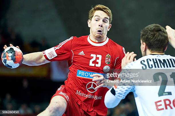 Rudolf Faluvegi of Hungary throws the ball against Erik Schmidt of Germany during the Men's EHF Handball European Championship 2016 match between...