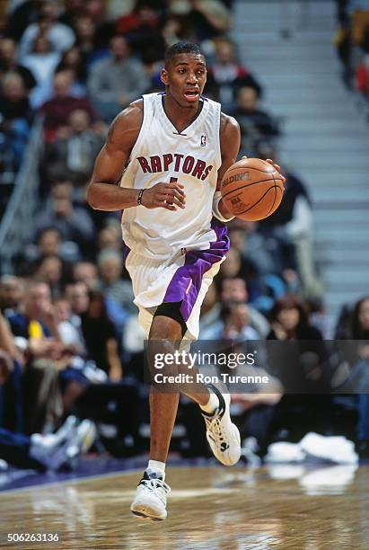 Tracy McGrady of the Toronto Raptors drives against the Indiana Pacers on December 14, 1999 at the Air Canada Centre in Toronto, Ontario in Canada....