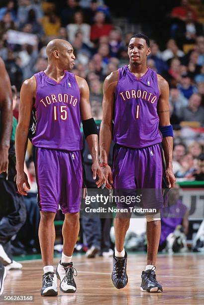 Vince Carter and Tracy McGrady of the Toronto Raptors chats against the Boston Celtics on March 1, 2000 at the Fleet Center in Boston, Massachusetts....