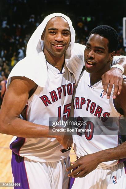 Vince Carter and Alvin Williams of the Toronto Raptors celebrates against the New York Knicks on April 14, 2000 at the Air Canada Centre in Toronto,...