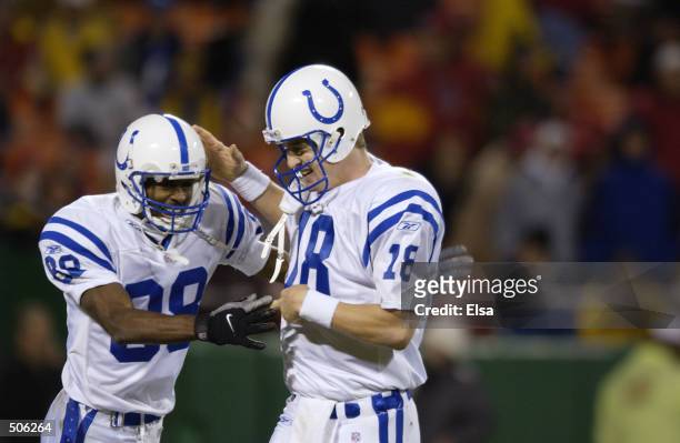 Peyton Manning of the Indianapolis Colts congratulates Marvin Harrison after scoring a touchdown against the Kansas City Chiefs during the game at...