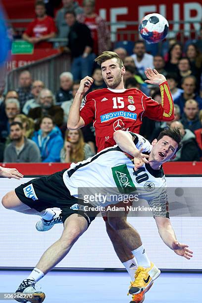 Simon Ernst from Germany fights for the ball with Peter Hornyak from Hungary during the Men's EHF Handball European Championship 2016 match between...